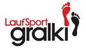Logo Laufsport Gralki Logo von Laufsport Gralki mit rotem und schwarzem Fußabdruck und markanter schwarzer Schrift